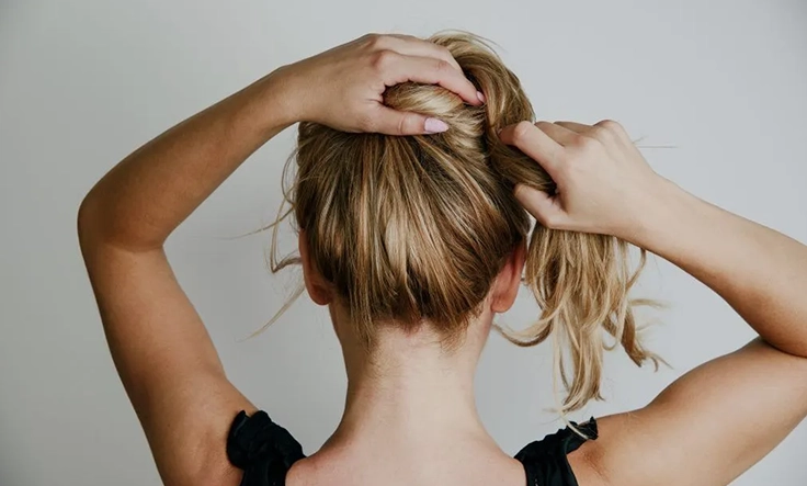 Let your hair air-dry instead of tying damp hair to reduce brittleness and prevent breakage.