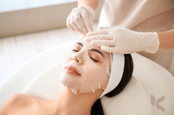 A woman indulging in a facial at a spa, relishing in the soothing and revitalizing sensation